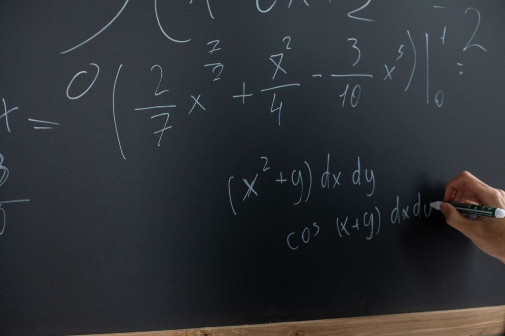 Mathematics and physics equations in a notebook for JEE Main 2027 preparation